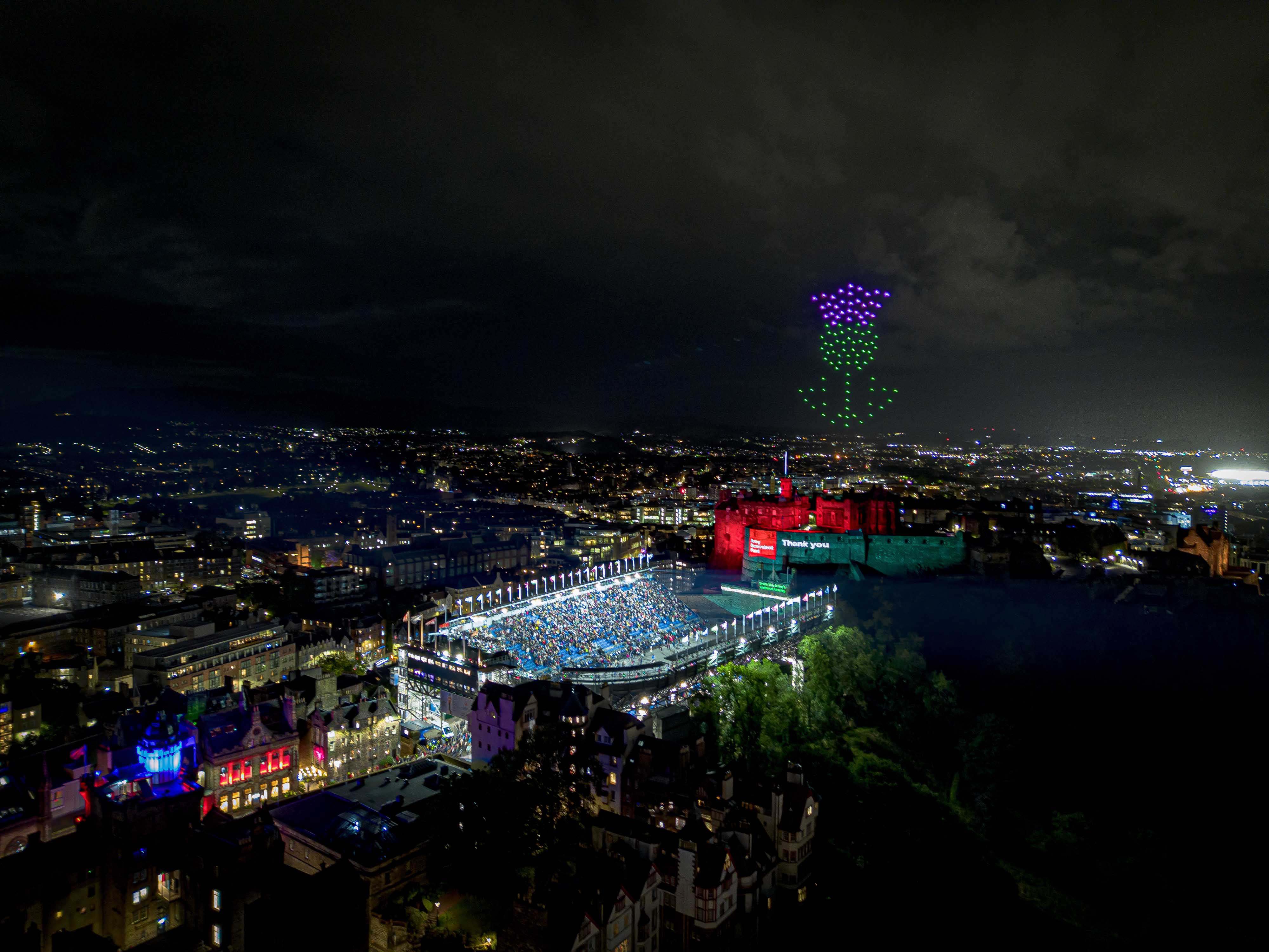 100 drones flying over Edinburgh Castle for The Royal Edinburgh Military Tattoo forming a giant thistle